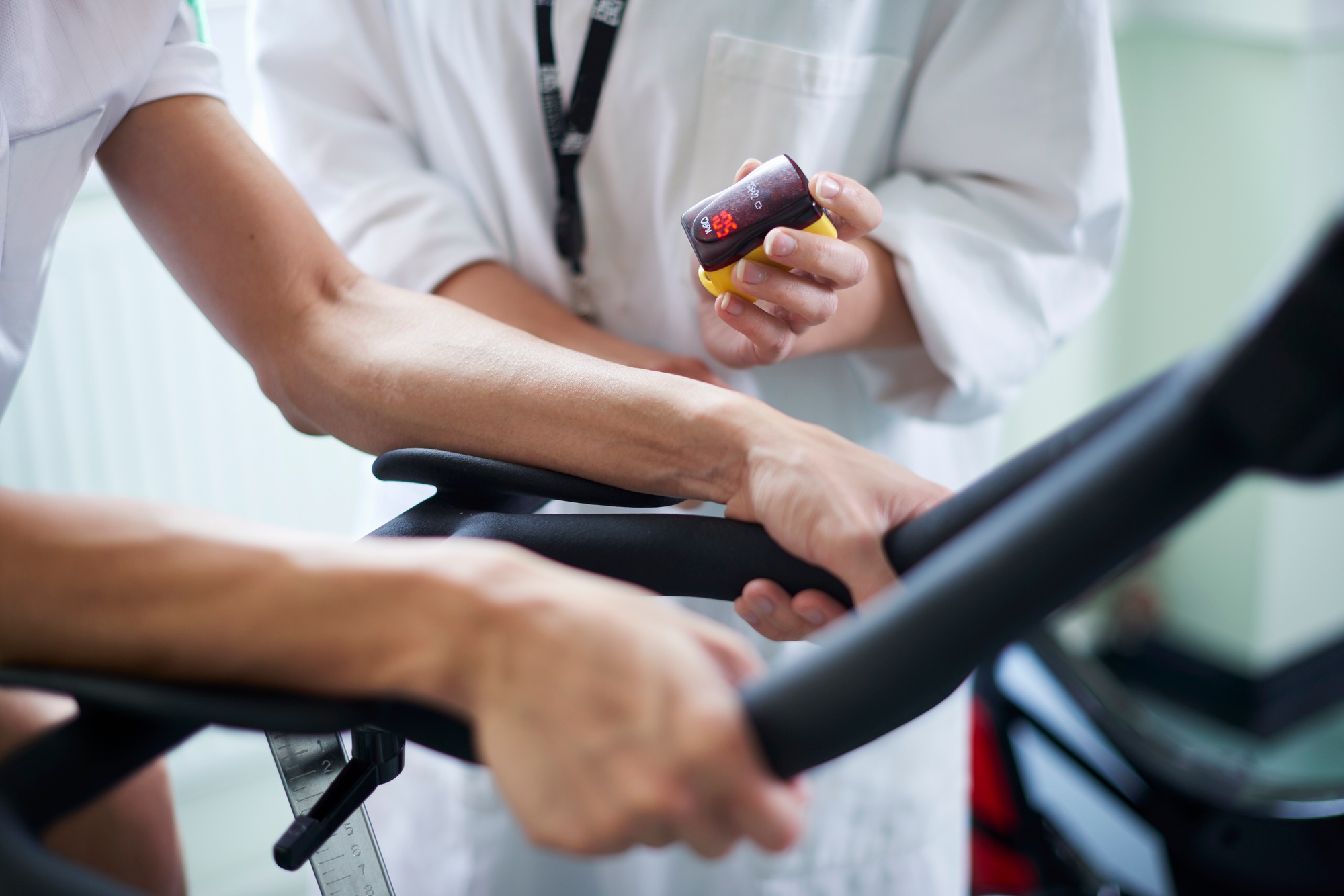 Doctor checking patient's heart rate during a treadmill test