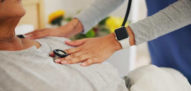 Doctor, hands and checking patient heart beat with stethoscope for healthcare or monitoring at home