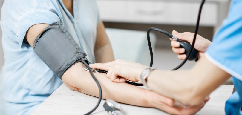 Nurse measuring blood pressure of a senior patient