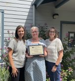 Kelly Thompson, Chief of Nursing, Deborah Dillon, Director of Patient Safety & Quality and Heidi Anderson, CEO pose with the 2026 Rural Hospital Achievement of Quality Excellence Gold Award from the Washington State Hospital Association in front of Forks Hospital